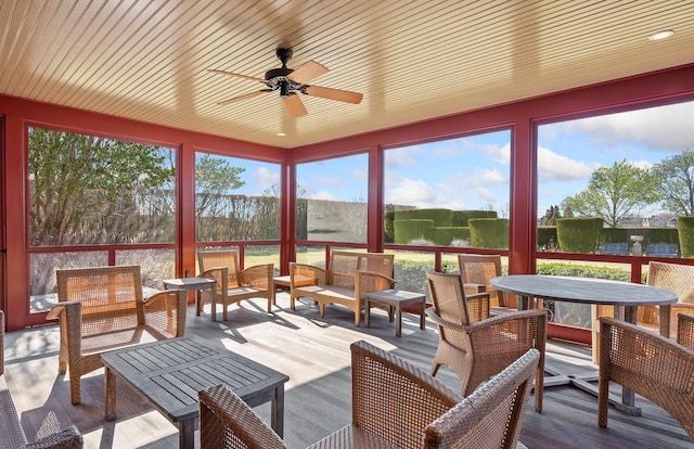 sunroom with outdoor lounge area, wood finished floors, and ceiling fan