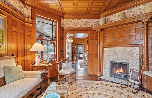 living room featuring a tiled fireplace, wood ceiling, ornamental molding, and wood finished floors