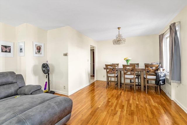 146-38 26th Ave, Flushing, NY 11354 - living area with light wood-style floors and a chandelier