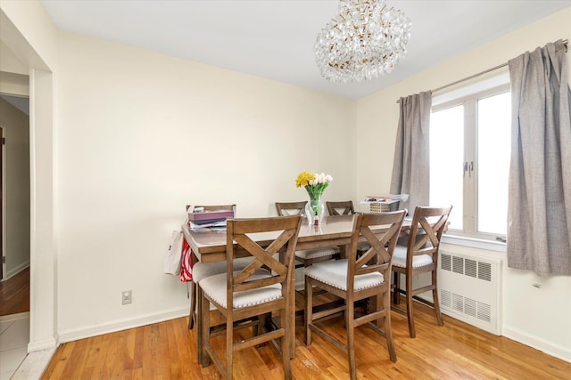 146-38 26th Ave, Flushing, NY 11354 - dining room featuring radiator heating unit, a chandelier, and light wood finished floors