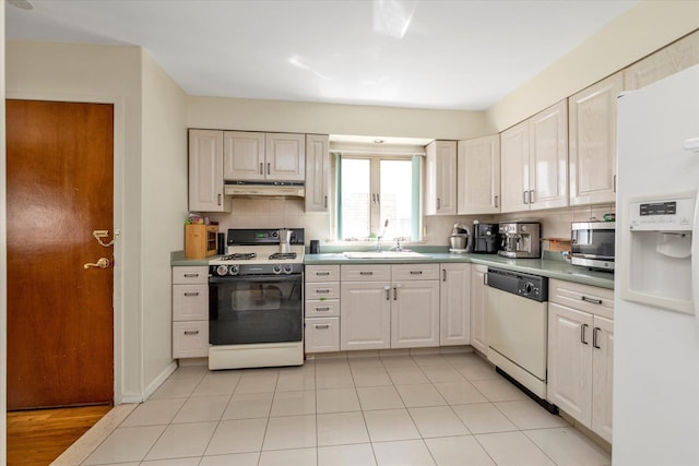 146-38 26th Ave, Flushing, NY 11354 - kitchen with white appliances, under cabinet range hood, decorative backsplash, light tile patterned floors, and light countertops