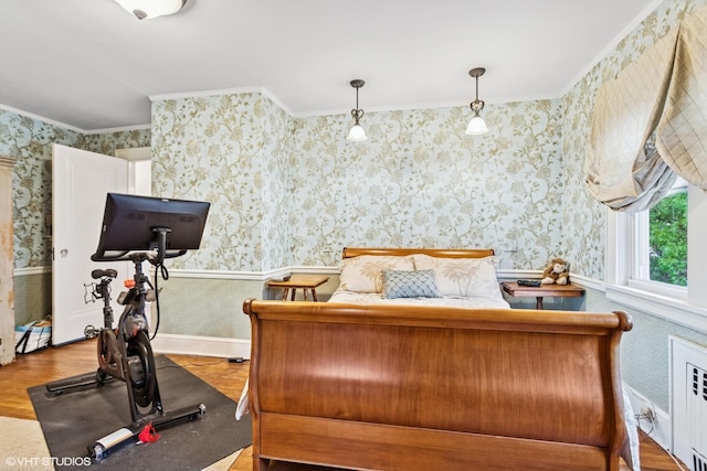 bedroom featuring wallpapered walls, crown molding, wood finished floors, radiator heating unit, and wainscoting