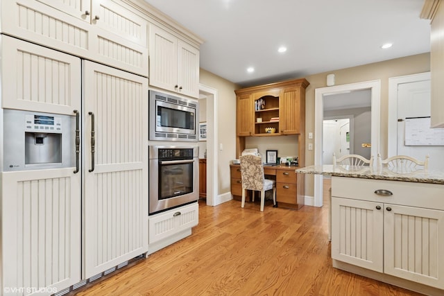 kitchen featuring built in appliances, light wood-style floors, light stone counters, recessed lighting, and open shelves