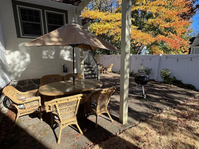 view of patio / terrace featuring a fenced backyard, outdoor dining space, and a deck