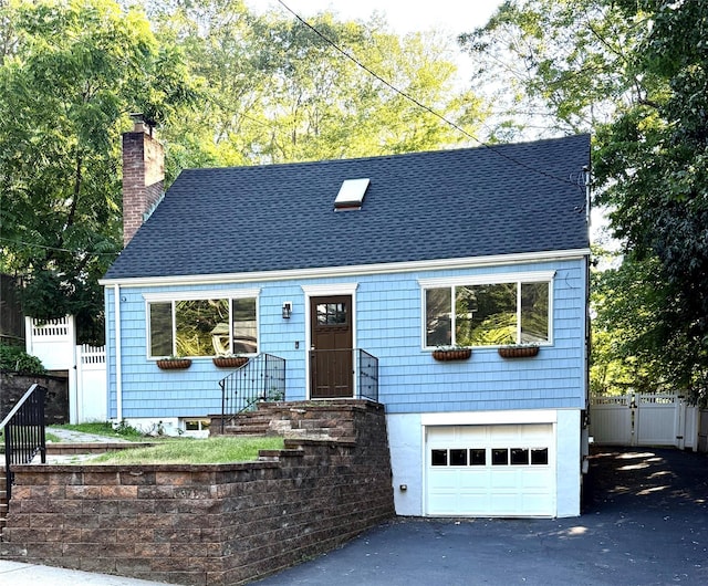 37 Soundview Rd, Huntington, NY 11743 - view of front facade featuring a garage, a chimney, asphalt driveway, and roof with shingles