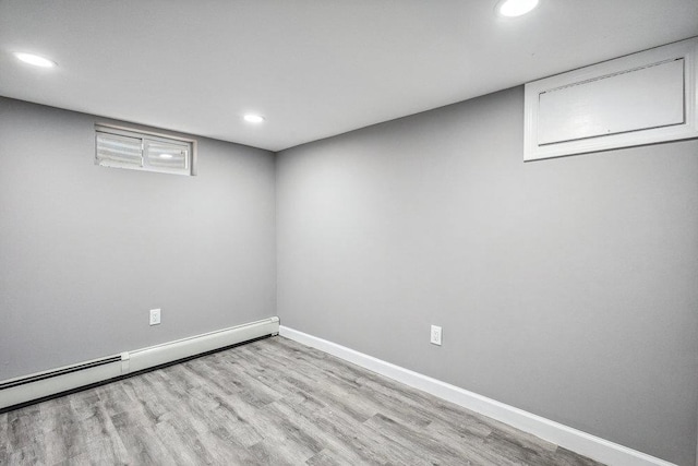 37 Soundview Rd, Huntington, NY 11743 - finished basement featuring a baseboard heating unit, recessed lighting, and wood finished floors