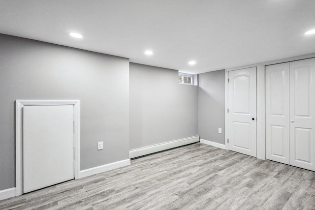 37 Soundview Rd, Huntington, NY 11743 - basement with a baseboard heating unit, wood finished floors, and recessed lighting
