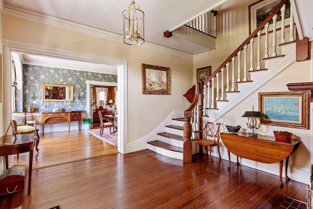 35 S Penataquit Ave, Bay Shore, NY 11706 - staircase featuring wood finished floors, ornamental molding, baseboards, and wallpapered walls
