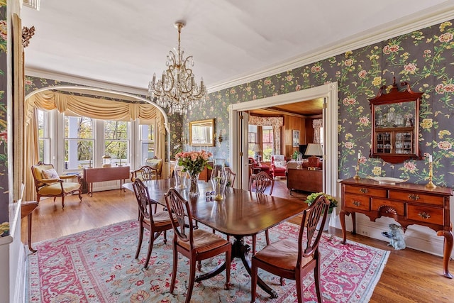 35 S Penataquit Ave, Bay Shore, NY 11706 - dining room with wallpapered walls, wood finished floors, ornamental molding, and a chandelier