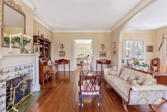 35 S Penataquit Ave, Bay Shore, NY 11706 - living area featuring arched walkways, wood finished floors, ornamental molding, a high end fireplace, and baseboards