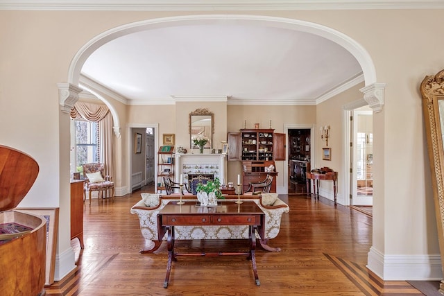 35 S Penataquit Ave, Bay Shore, NY 11706 - living area with arched walkways, a tiled fireplace, wood finished floors, ornamental molding, and baseboards