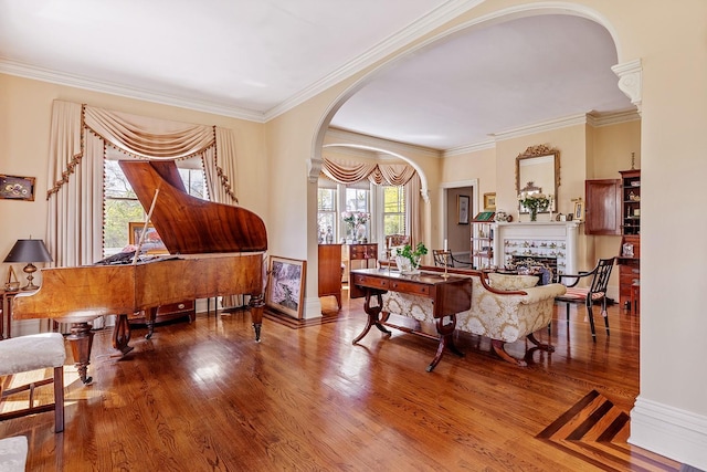 35 S Penataquit Ave, Bay Shore, NY 11706 - living area featuring wood finished floors, ornamental molding, arched walkways, and a tiled fireplace