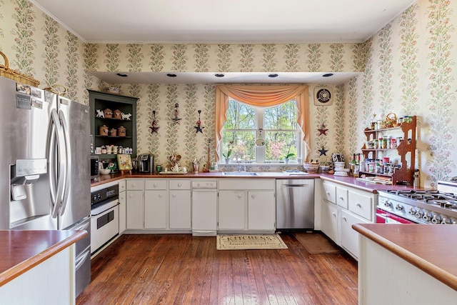 35 S Penataquit Ave, Bay Shore, NY 11706 - kitchen with appliances with stainless steel finishes, dark wood-style floors, wallpapered walls, white cabinets, and open shelves