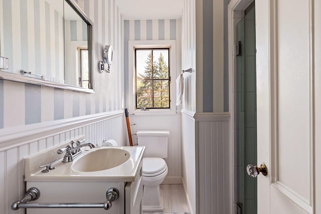 35 S Penataquit Ave, Bay Shore, NY 11706 - full bathroom with wallpapered walls, toilet, wainscoting, vanity, and wood finished floors