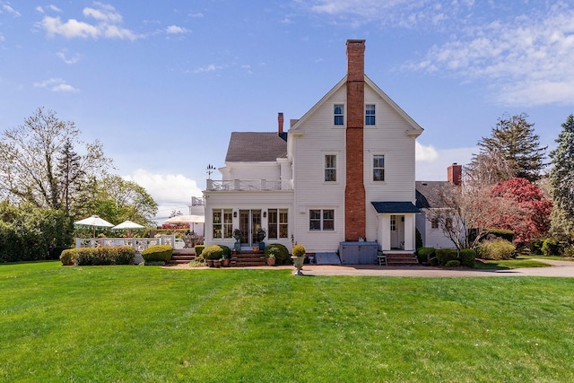35 S Penataquit Ave, Bay Shore, NY 11706 - rear view of property featuring a balcony, a yard, and a chimney