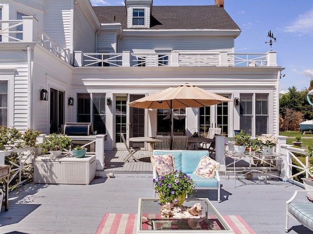 35 S Penataquit Ave, Bay Shore, NY 11706 - back of property featuring a balcony, outdoor lounge area, a chimney, and a wooden deck