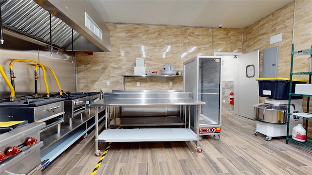 miscellaneous room with tile walls, beverage cooler, and wood finished floors