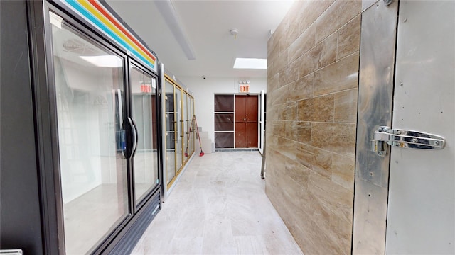 hallway featuring tile walls