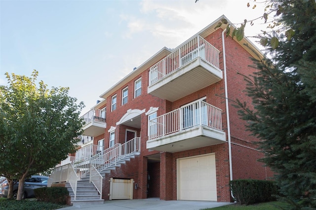 121-10 Powells Cove Blvd Unit C, College Point, NY 11356 - view of building exterior with an attached garage