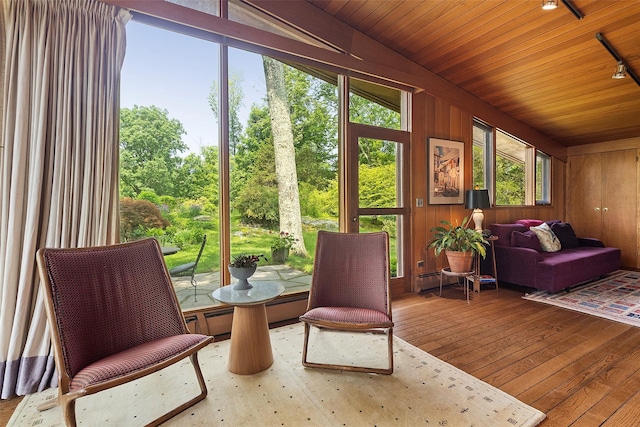 280 Salem Rd, Pound Ridge, NY 10576 - sunroom / solarium featuring lofted ceiling, rail lighting, and view of wooded area