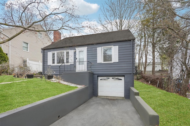 view of front facade featuring a front yard, driveway, a garage, and a chimney