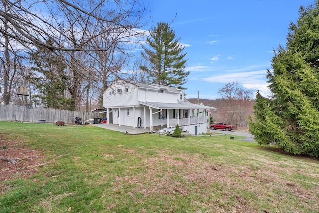 rear view of property featuring a porch