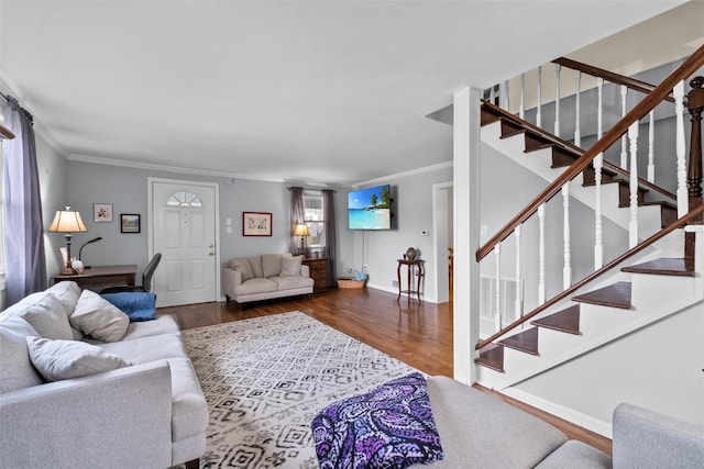 living area featuring crown molding, wood finished floors, and stairs