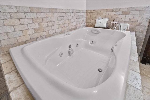 bathroom with a tub with jets