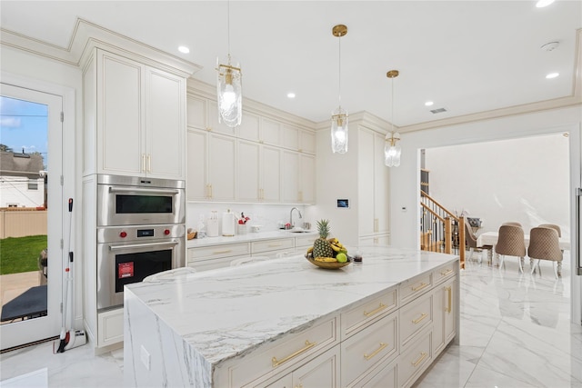 783 Oakleigh Rd, North Woodmere, NY 11581 - kitchen featuring double oven, marble finish floor, light stone counters, a sink, and a kitchen island