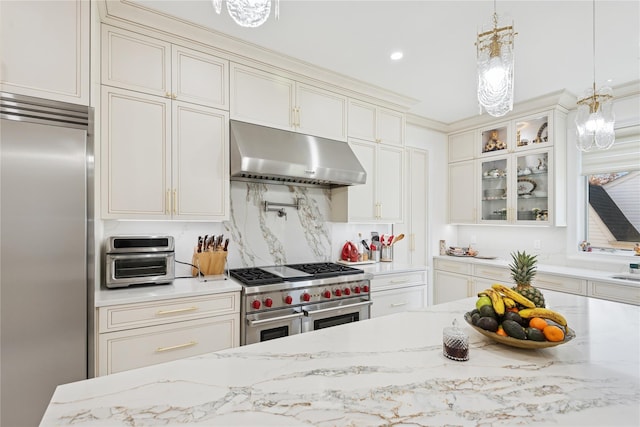 783 Oakleigh Rd, North Woodmere, NY 11581 - kitchen featuring hanging light fixtures, high end appliances, glass insert cabinets, an inviting chandelier, and under cabinet range hood