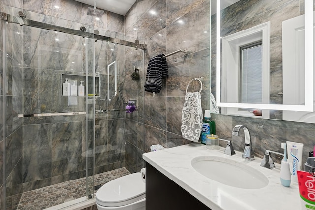 783 Oakleigh Rd, North Woodmere, NY 11581 - full bathroom with a shower stall, toilet, vanity, tile walls, and tasteful backsplash