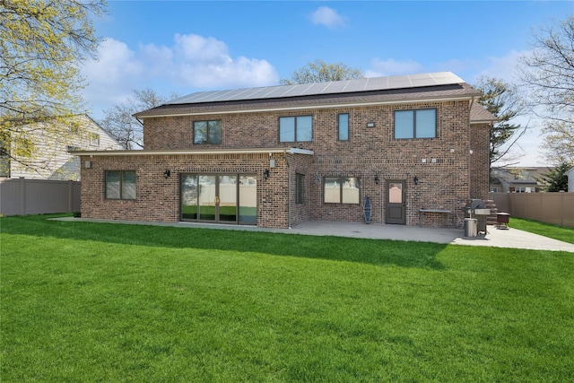 783 Oakleigh Rd, North Woodmere, NY 11581 - back of house featuring a lawn, solar panels, and a patio area
