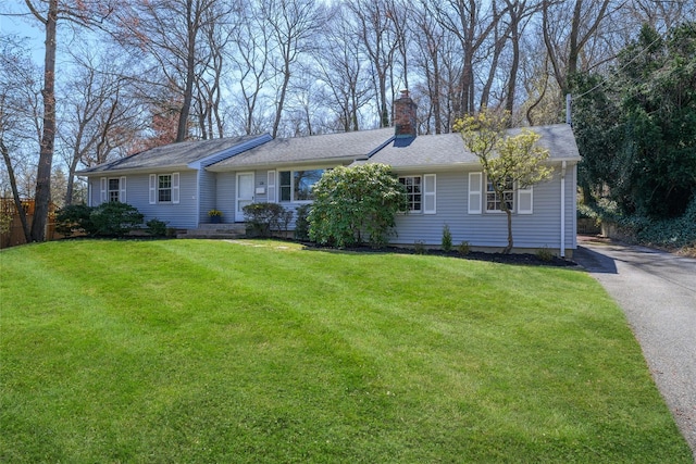 126 Bayville Ave, Bayville, NY 11709 - ranch-style home featuring aphalt driveway, a chimney, and a front lawn