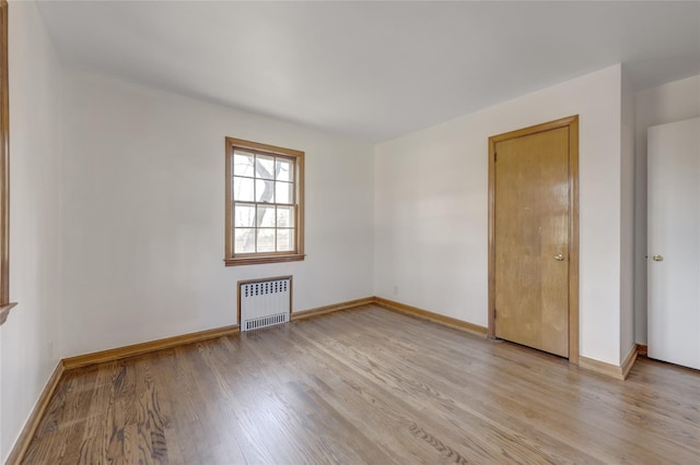 126 Bayville Ave, Bayville, NY 11709 - unfurnished room with light wood-style flooring, baseboards, and radiator
