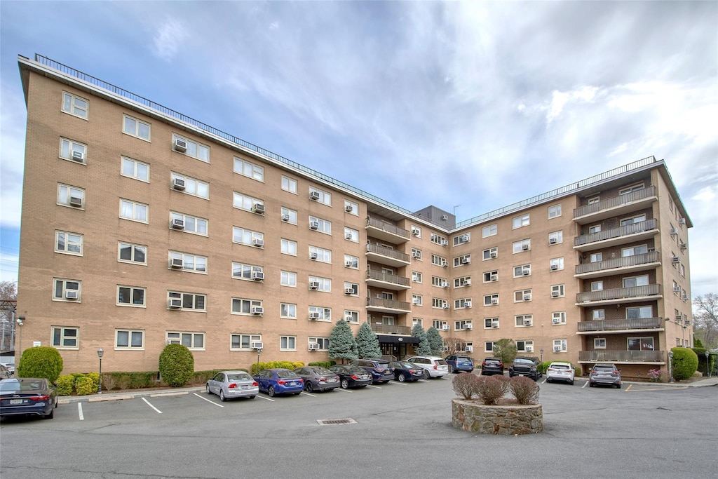view of building exterior featuring uncovered parking
