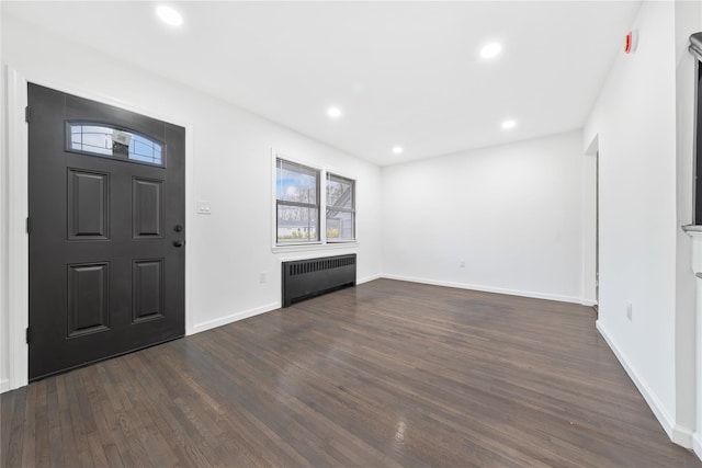 entryway with a healthy amount of sunlight, radiator, and dark wood finished floors