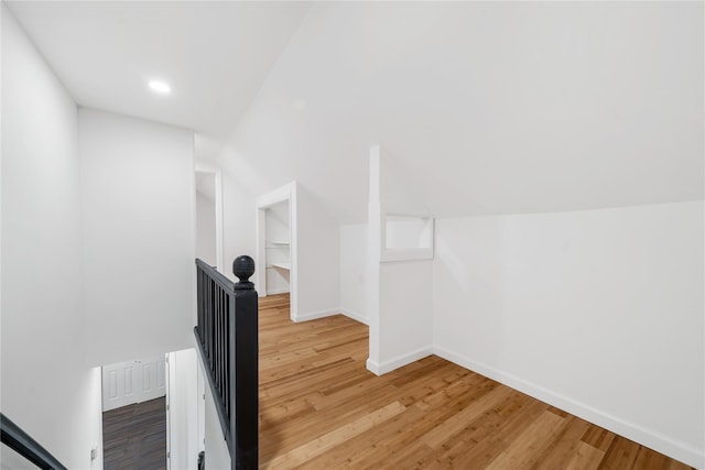 bonus room with recessed lighting, light wood-type flooring, baseboards, and lofted ceiling