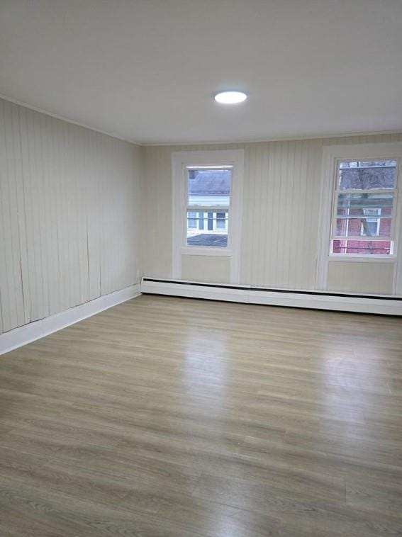 185 Mill St, Poughkeepsie, NY 12601 - spare room with baseboard heating, wood finished floors, and recessed lighting