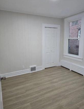 185 Mill St, Poughkeepsie, NY 12601 - empty room with wood finished floors and baseboards
