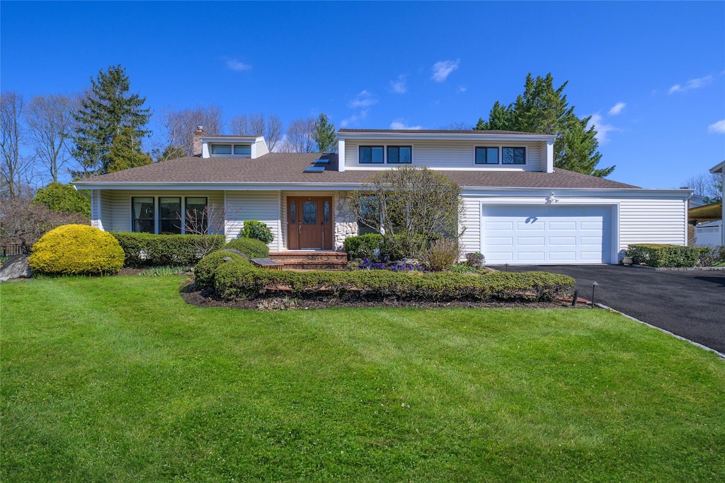 60 Juniper Ln, Muttontown, NY 11791 - traditional-style house with a front yard, roof with shingles, driveway, and an attached garage