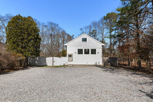 4 Evelyn Ct, Westhampton, NY 11978 - view of side of property with gravel driveway and a gate
