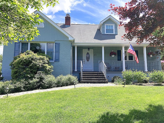 43 Glenwood Rd, New City, NY 10956 - view of front of property with covered porch, a front yard, a chimney, and roof with shingles