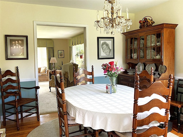 43 Glenwood Rd, New City, NY 10956 - dining space featuring wood finished floors and a chandelier