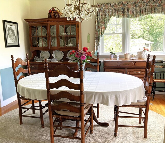 43 Glenwood Rd, New City, NY 10956 - dining space featuring light wood finished floors, a chandelier, healthy amount of natural light, and baseboards