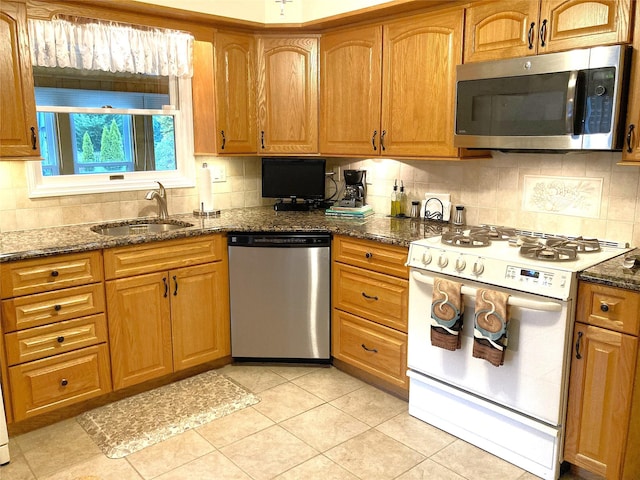 43 Glenwood Rd, New City, NY 10956 - kitchen featuring appliances with stainless steel finishes, a sink, dark stone counters, and backsplash