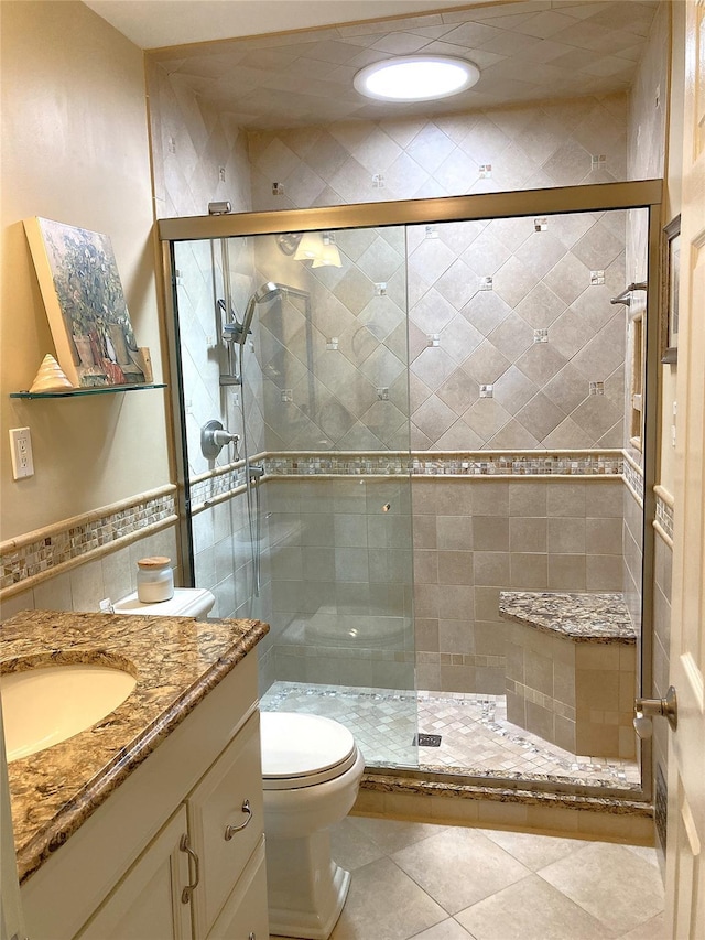 43 Glenwood Rd, New City, NY 10956 - bathroom with toilet, vanity, a shower stall, tile walls, and tile patterned flooring