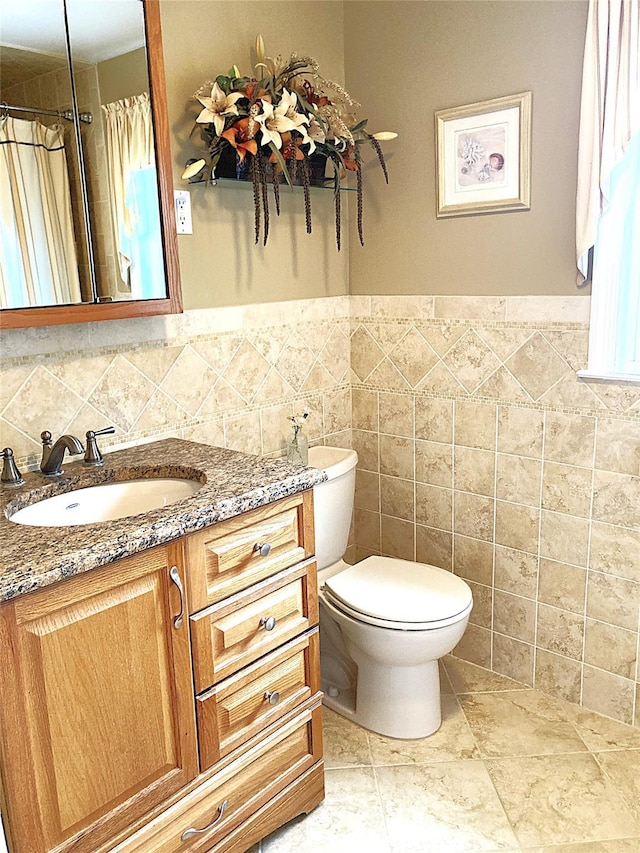 43 Glenwood Rd, New City, NY 10956 - full bathroom with vanity, toilet, tile walls, wainscoting, and a shower with shower curtain
