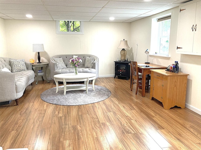 43 Glenwood Rd, New City, NY 10956 - living room with a wood stove, light wood-type flooring, a paneled ceiling, and baseboards