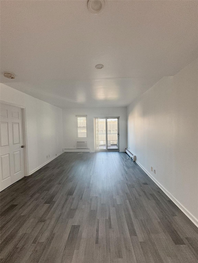 empty room with baseboards, dark wood-style floors, and a baseboard radiator
