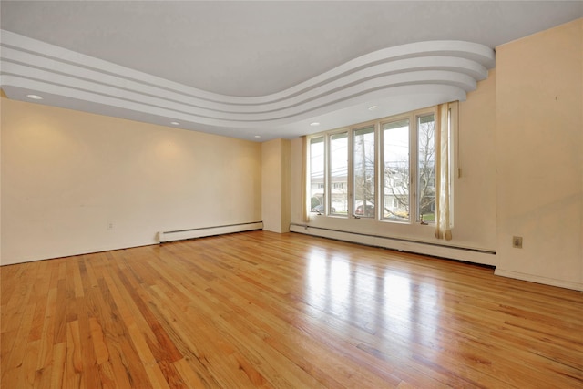 9 Ensign Dr, Massapequa, NY 11758 - unfurnished room featuring baseboard heating, wood finished floors, recessed lighting, and a baseboard radiator